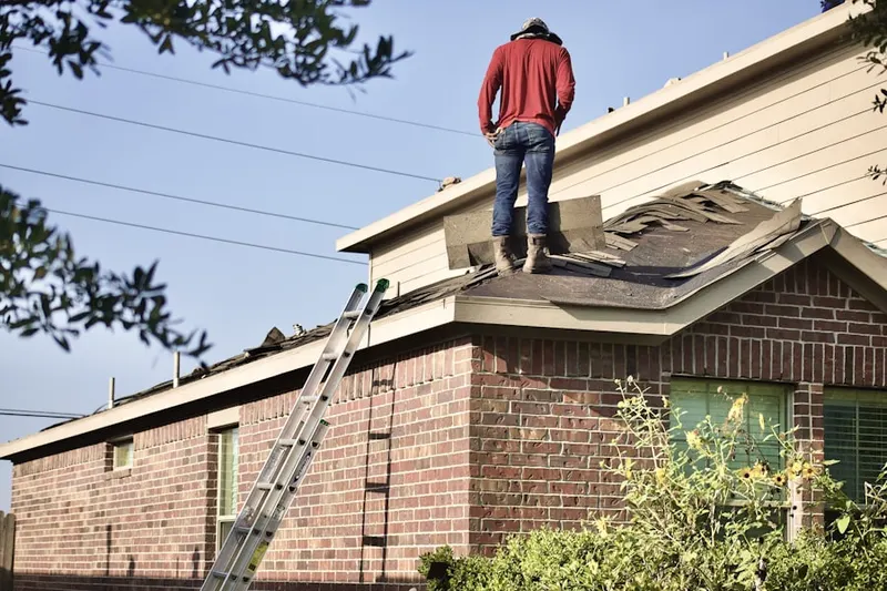 Professional roofer working on a residential roof in Fremont